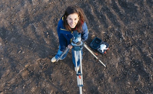 Archaeologist with surveying equipment.