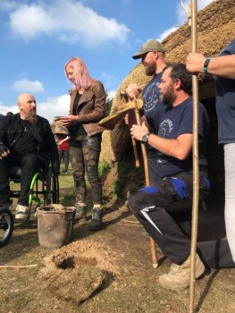 Stuart Prior and Alice Roberts next to reconstructed house at Butser Ancient Farm.